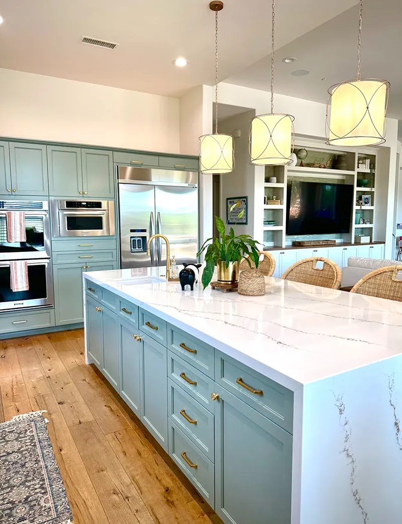Refaced kitchen with pale cabinets, island, and brass pulls, from Boyar's own website